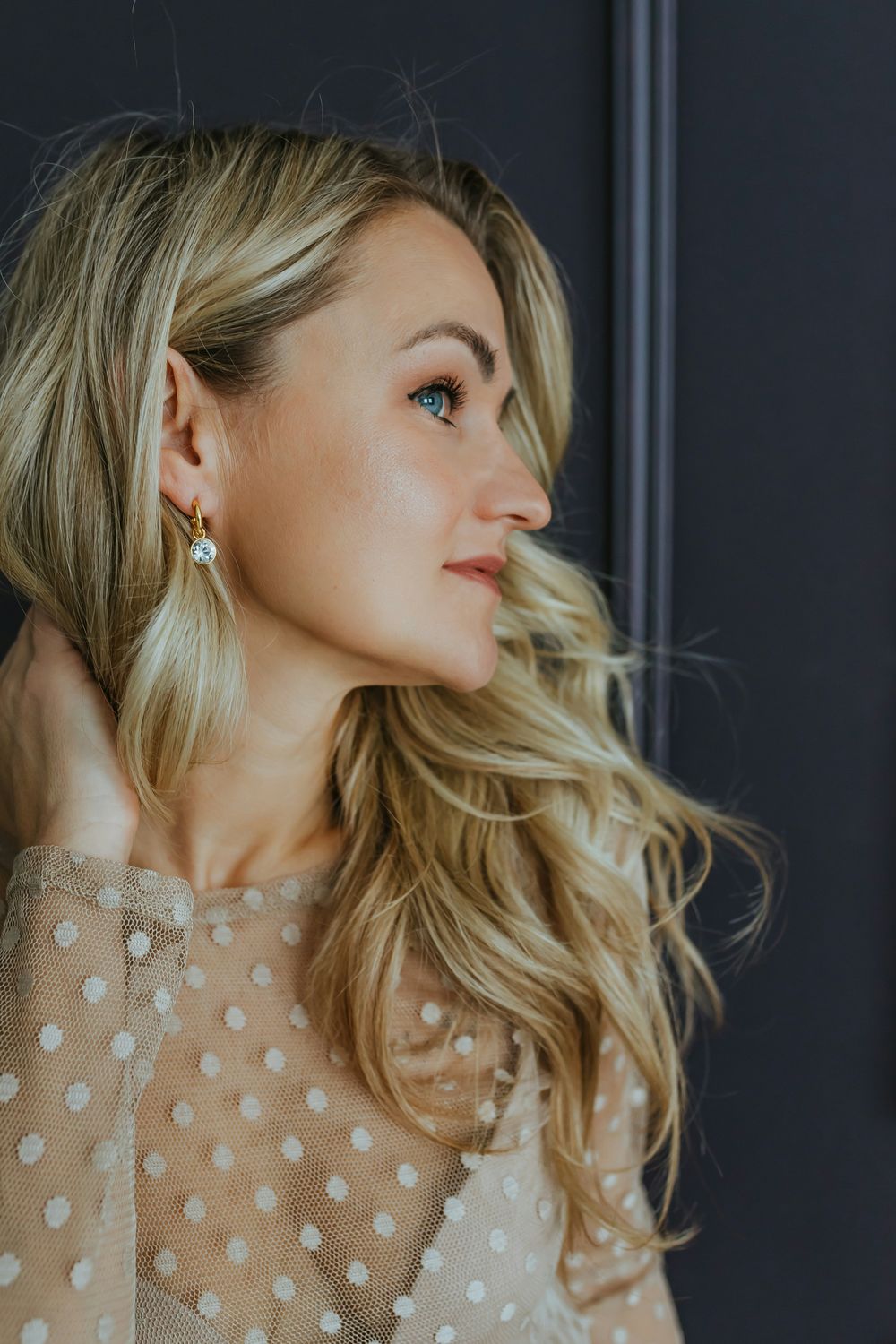 Smiling woman with long, wavy hair.