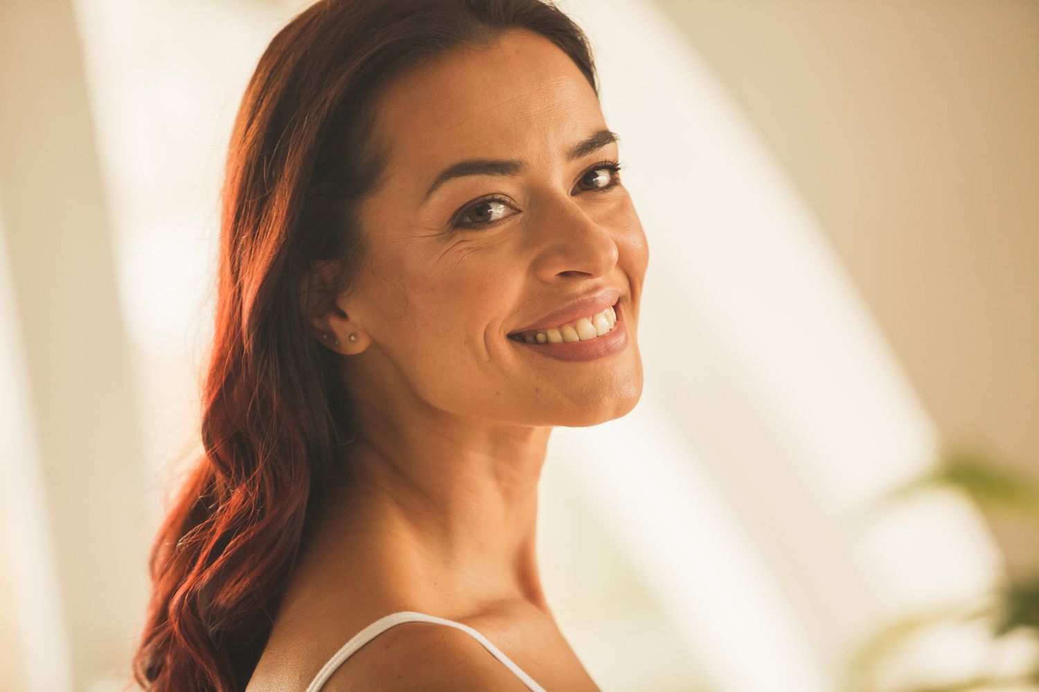 Model with elegant earrings and soft makeup.