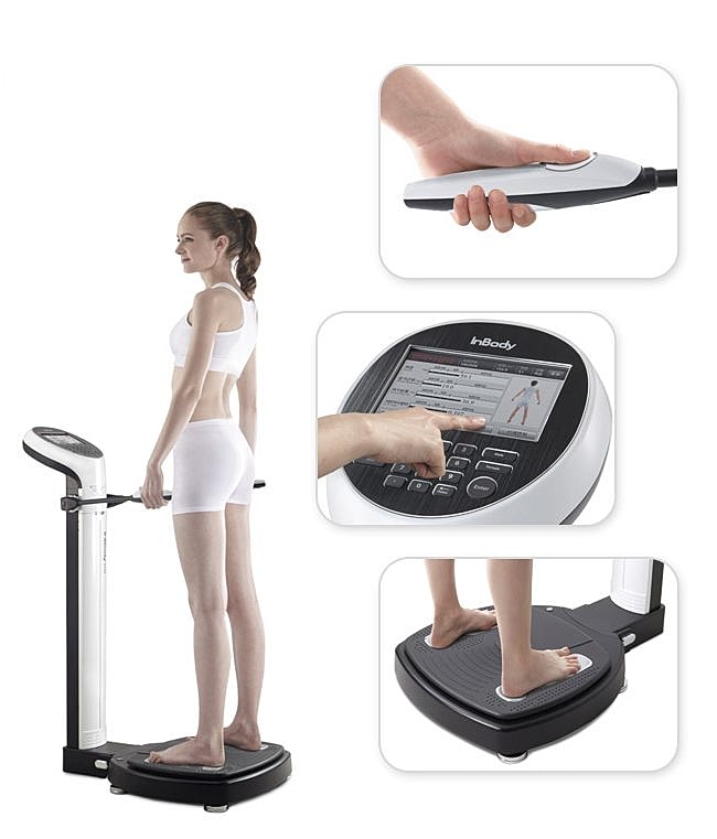 Body composition analyzer in use by a woman.