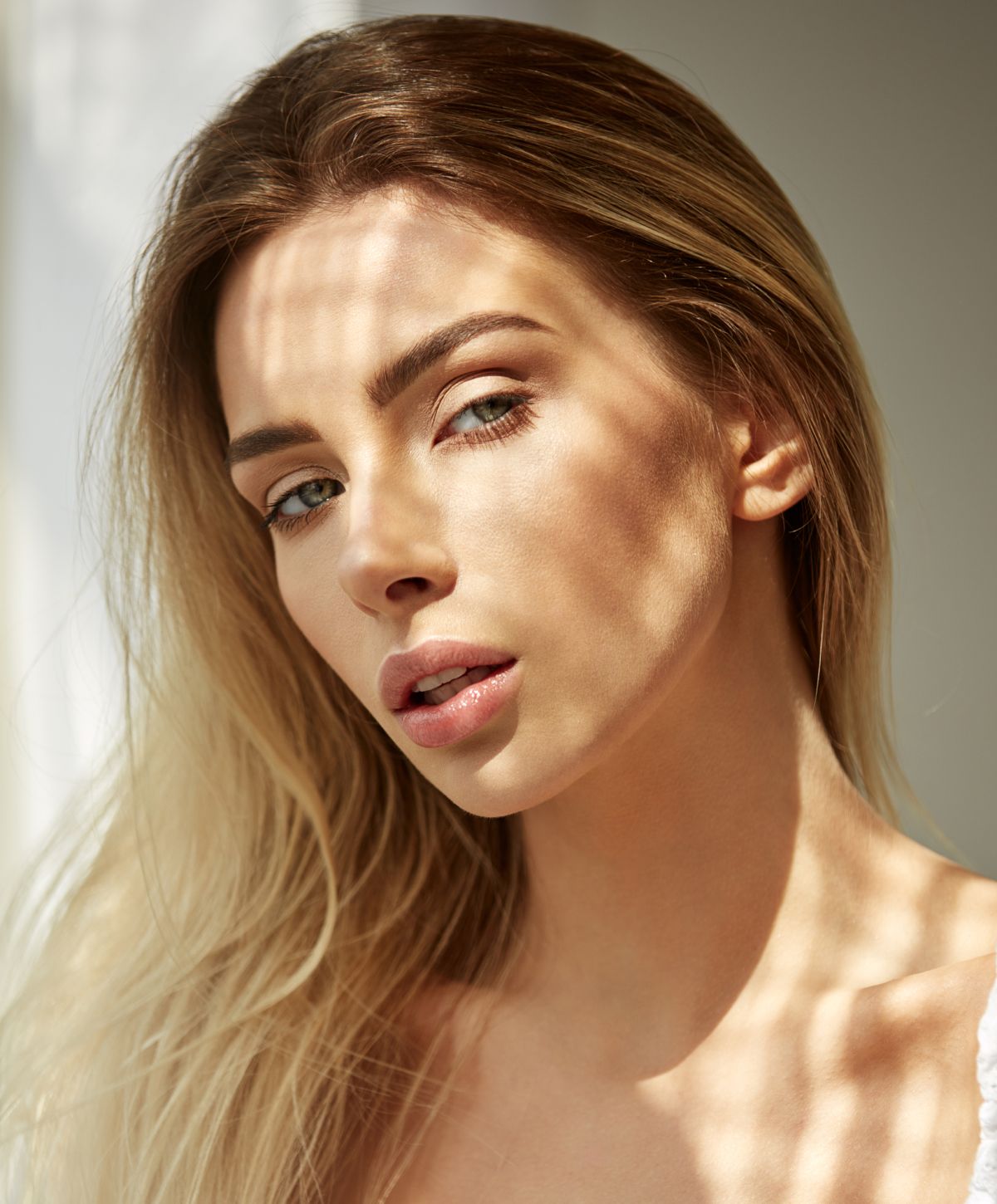 Close-up portrait with soft lighting and shadows.