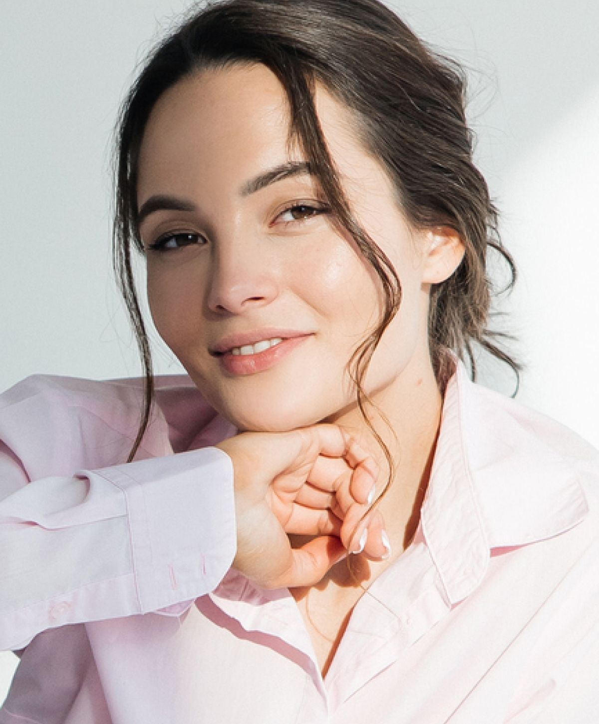 Smiling woman with brown hair and pink shirt