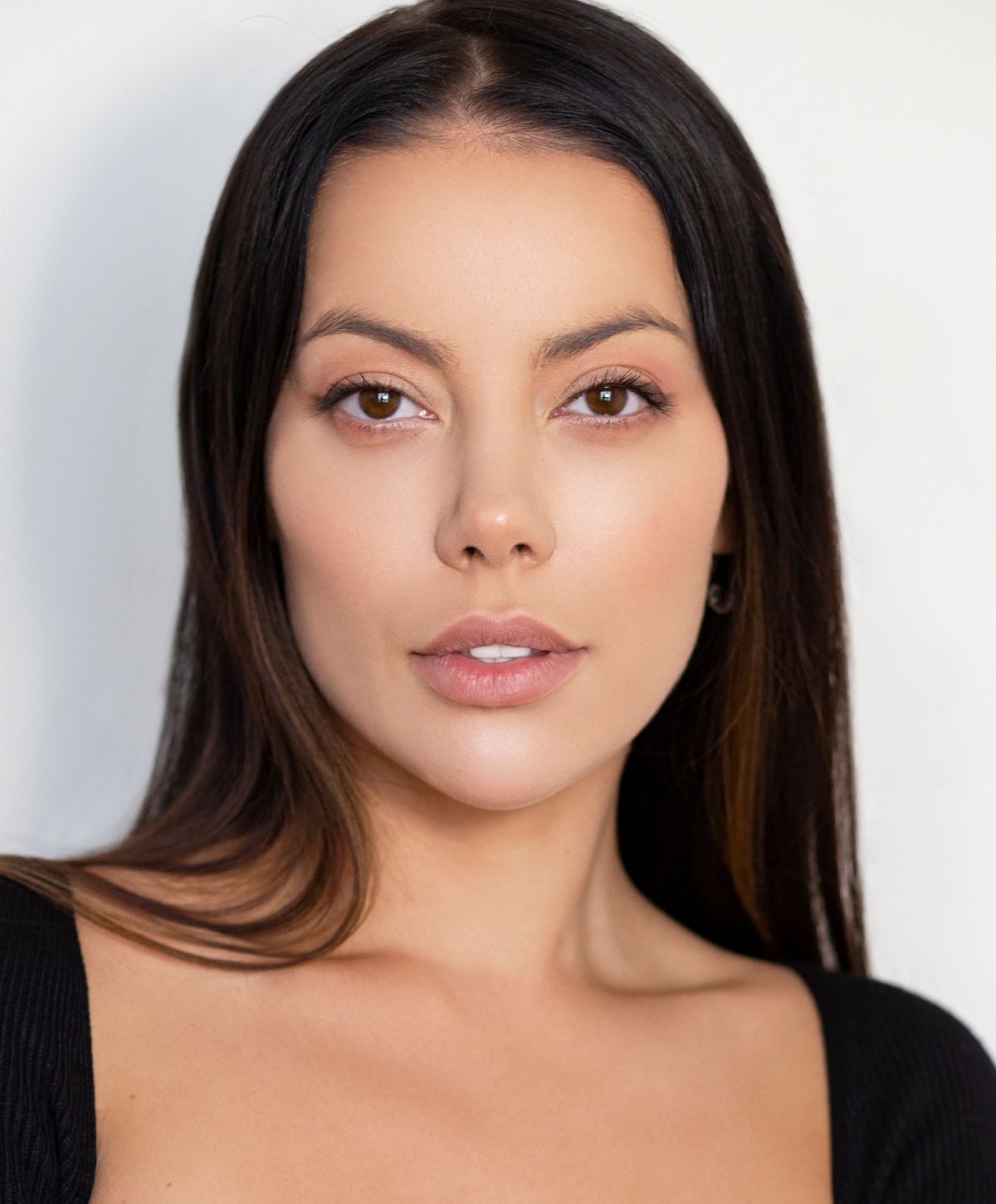 Portrait of a woman with long dark hair.