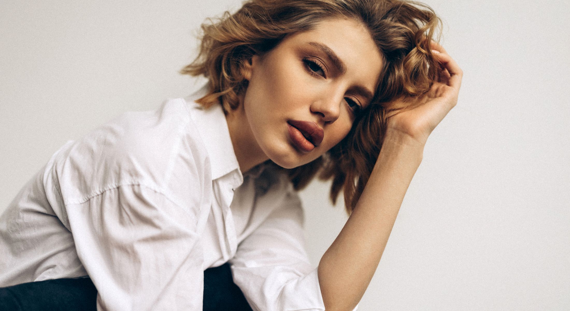 Portrait of a woman in a white shirt.