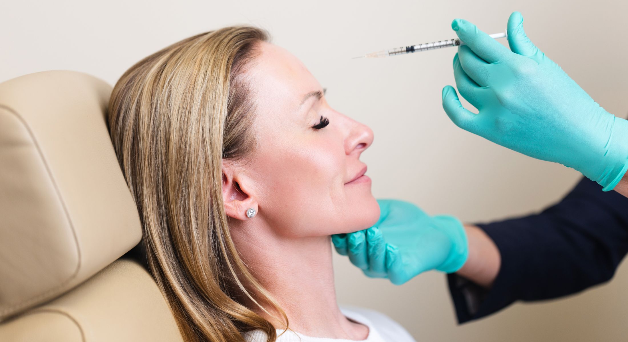 Woman receiving a cosmetic injection treatment.