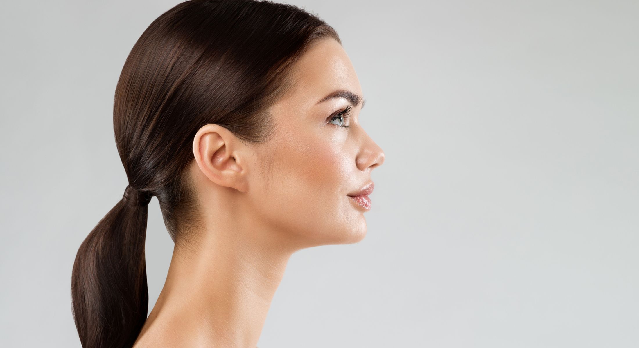Profile view of a woman with sleek hair.